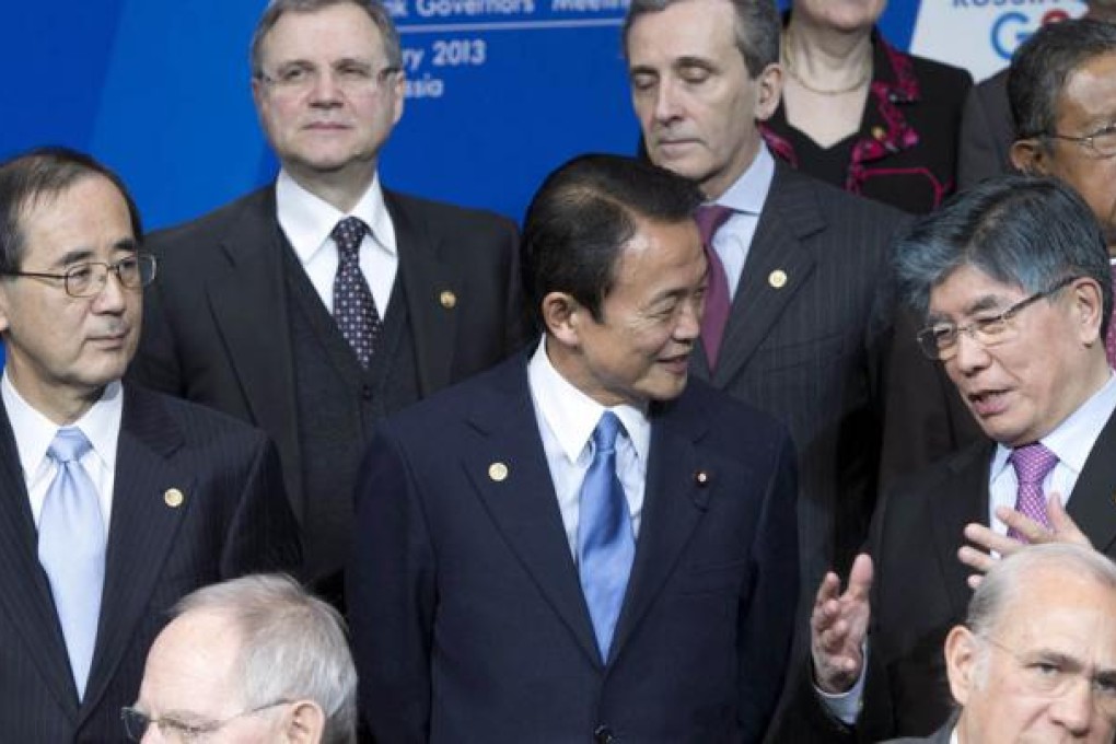Japan's finance minister, Taro Aso (centre), chats with South Korean Central Bank Governor Kim Choong-soo at the G20 meeting. Photo: AP