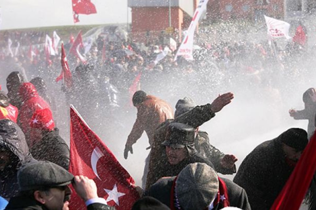 Turkish police fire water cannon and tear gas as they clash with hundreds of protesters trying to enter a courthouse in Silivri near Istanbul on Friday. Photo: AFP