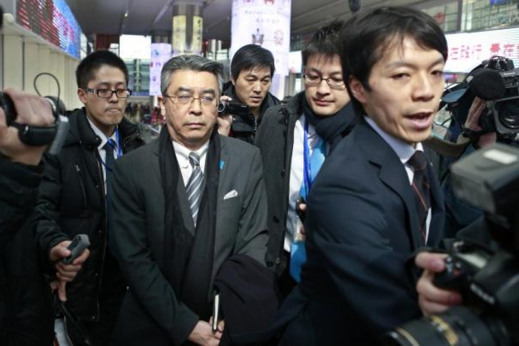 Shinsuke Sugiyama (second left) arrives in Beijing. Photo: Reuters