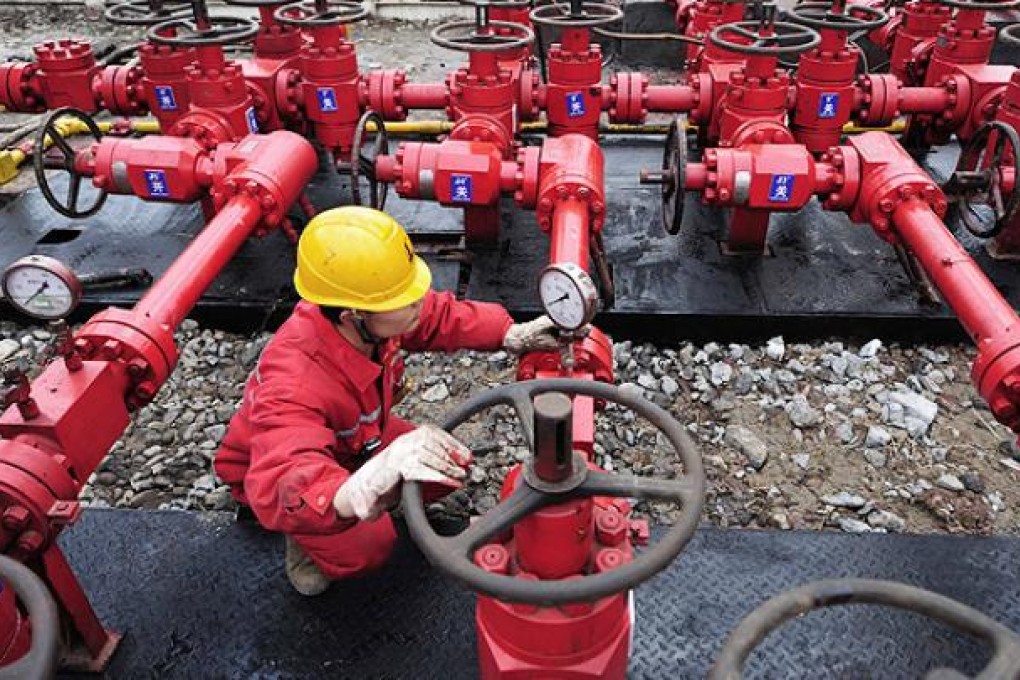 A worker performs valve checks at a Sinopec natural gas well in Sichuan. Photo: Reuters