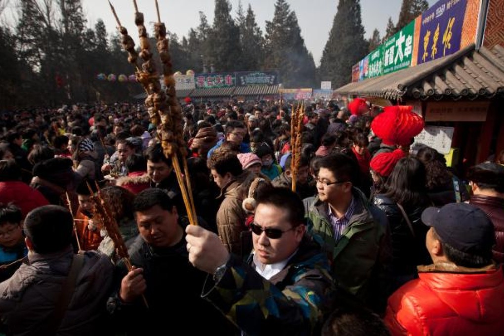 Beijingers relish mutton kebabs at Lunar New Year. Photo: AP
