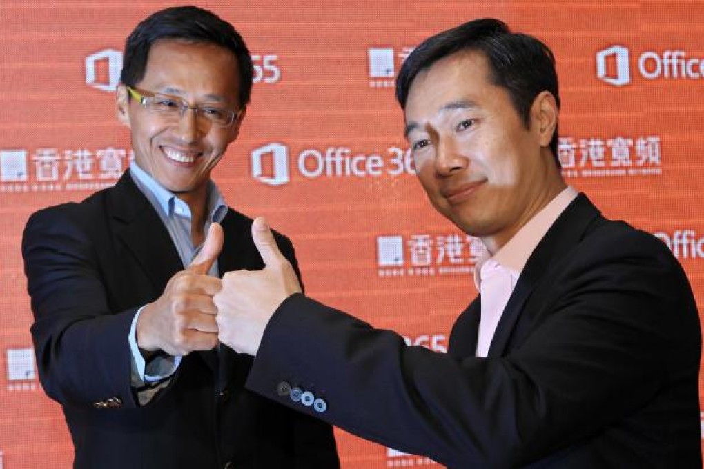 William Yeung of HKBN and Horace Chow of Microsoft celebrate the joint launch of the Office 'cloud' service in the city. Photo: Edward Wong