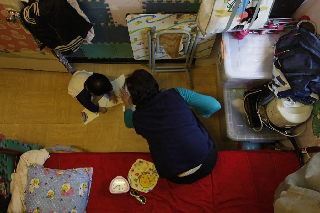 A single mother with her child in a subdivided flat. Photo: Reuters
