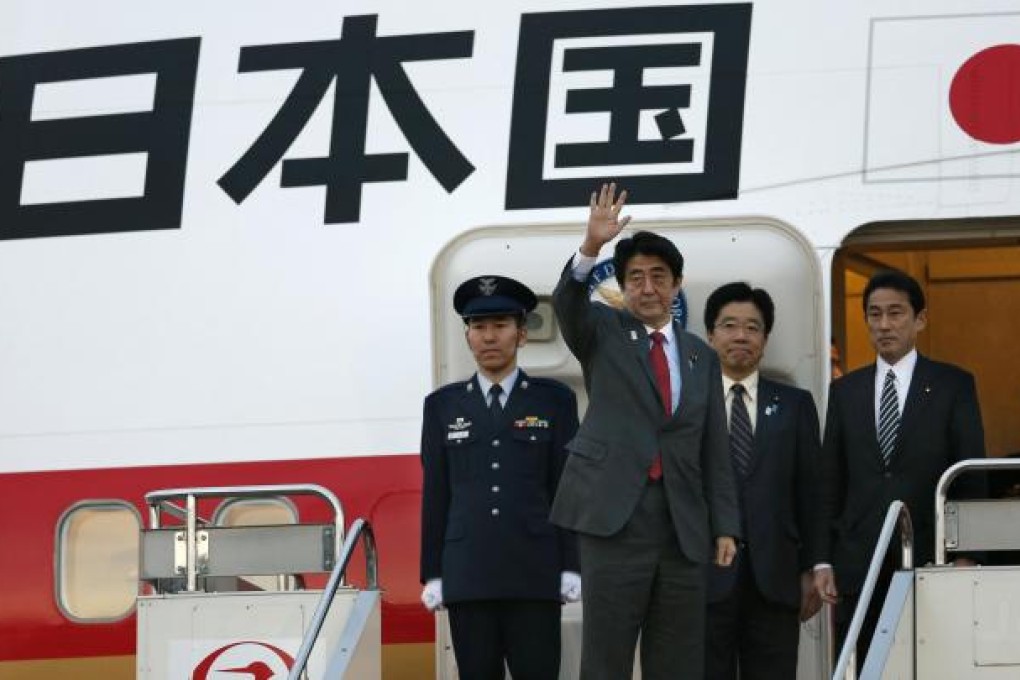 Japanese Prime Minister Shinzo Abe waves before his departure for Washington from Haneda International Airport in Tokyo. Photo: AP