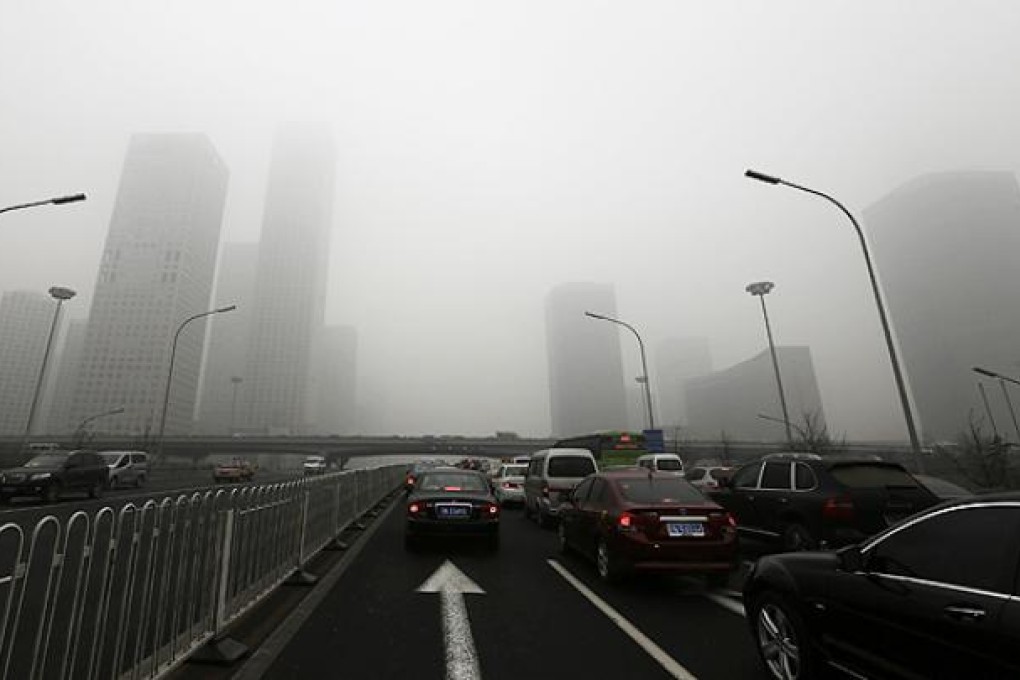 Cars drive on Jianguo Road on a heavily hazy day in Beijing. Reuters in Beijing
