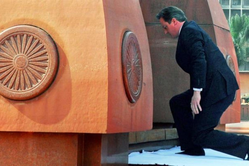 British prime minister pays his respects at the site of the 1919 massacre of hundreds of Indians by British troops. Photo: AP