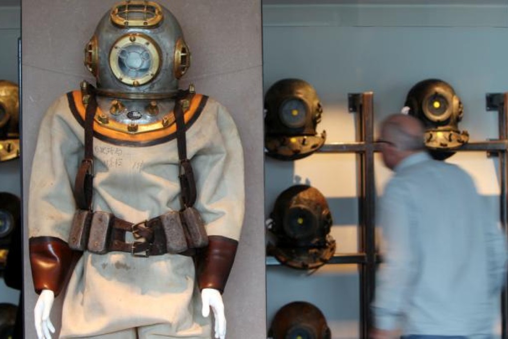 Diving helmets displayed at Hong Kong Maritime Museum. The brass bell of the former three-masted Chilean training ship, 'General Baquedano', will also be displayed as part of an exhibition. Photo: David Wong