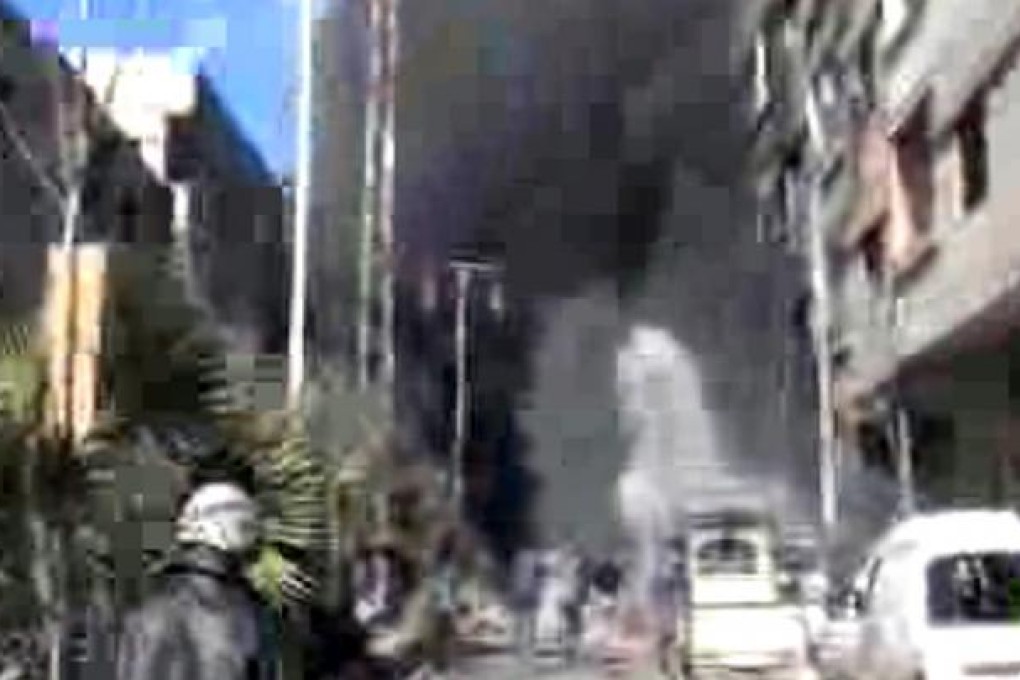 A Syrian army fighter jet crashes is shot down over a suburb of Damascus. Photo: AP