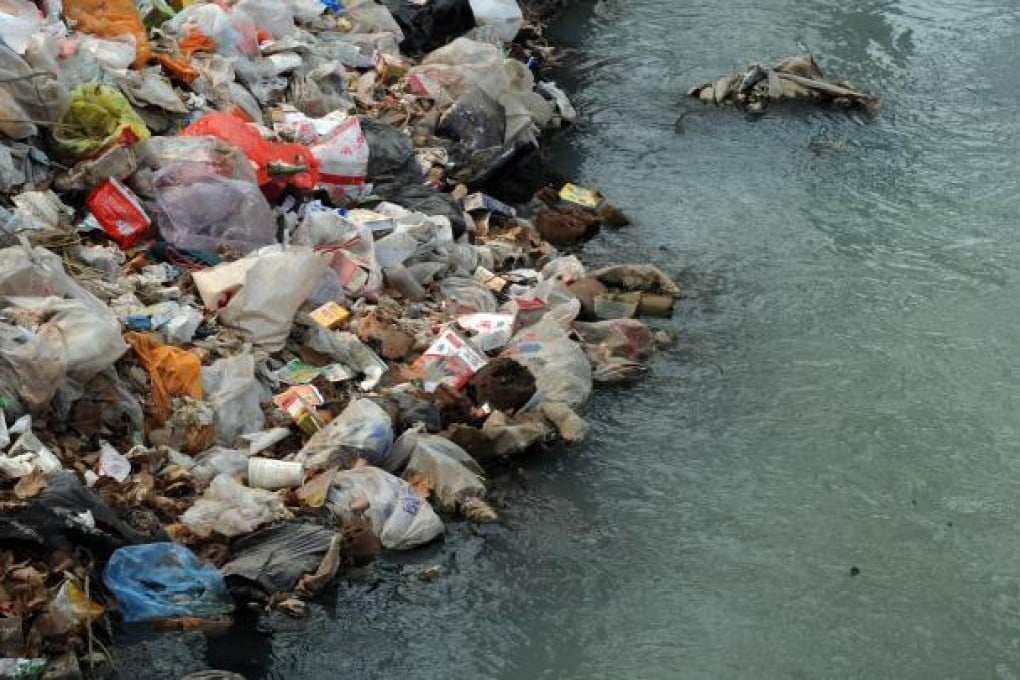 Rubbish clogs up a polluted canal on the edge of Beijing. Photo: AFP