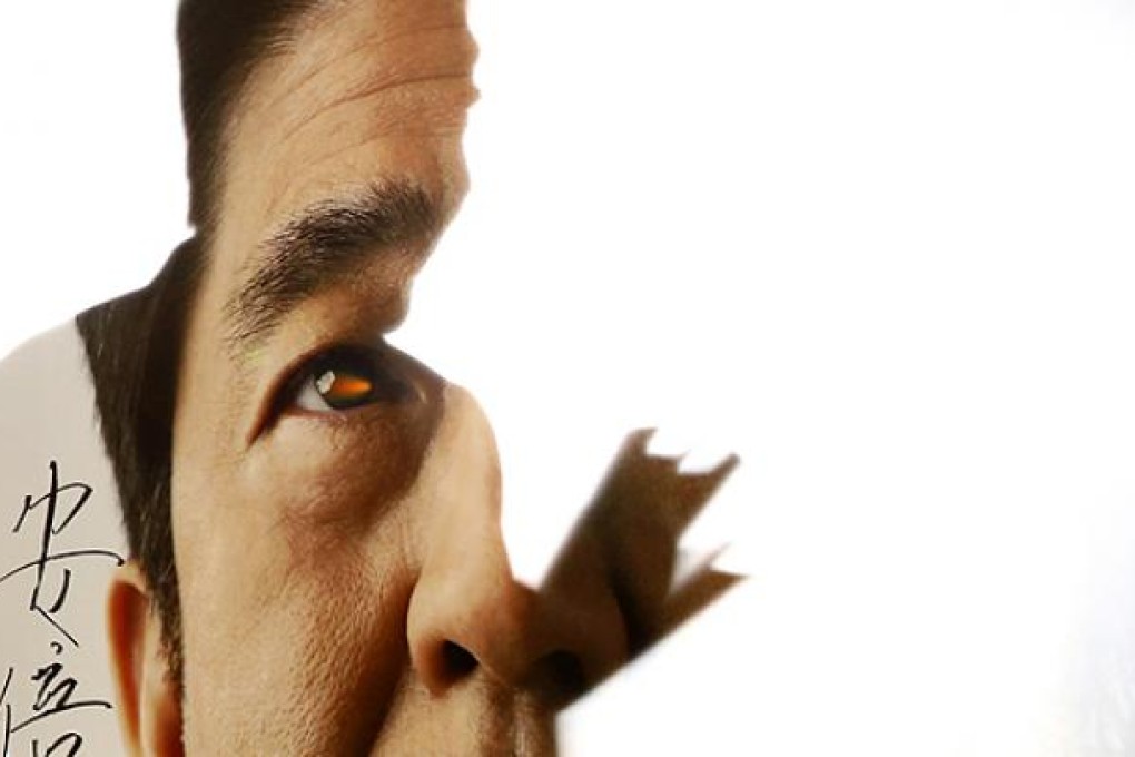 Shinzo Abe casts shadow on portrait after attending meeting at LDP headquarters in Tokyo. Photo: Reuters