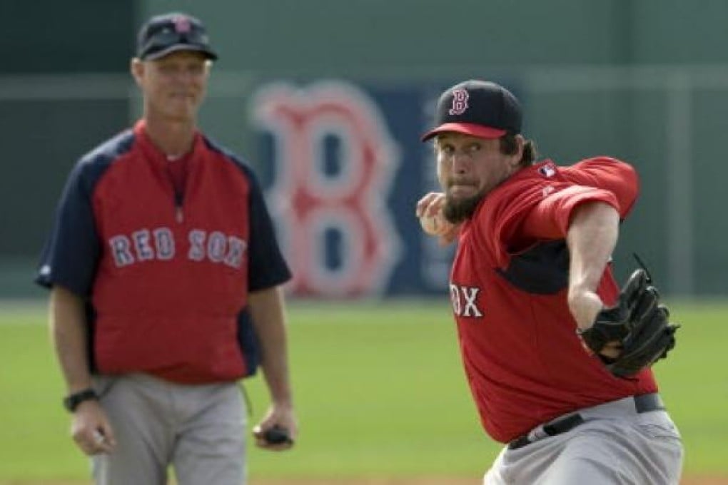 Boston Red Sox coach Bob Kipper watches Joel Hanrahan throw during batting practice at a workout at the team's MLB spring training complex in Fort Myers. Photo: Reuters.