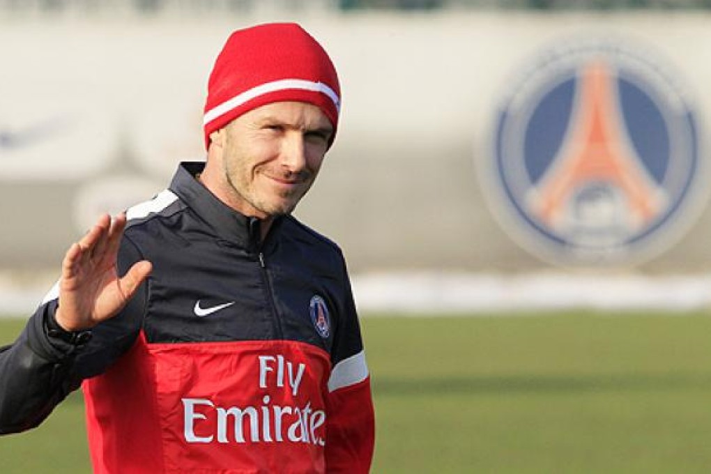David Beckham waves as he attends his first training session with the Paris Saint Germain squad on February 13. Photo: Reuters