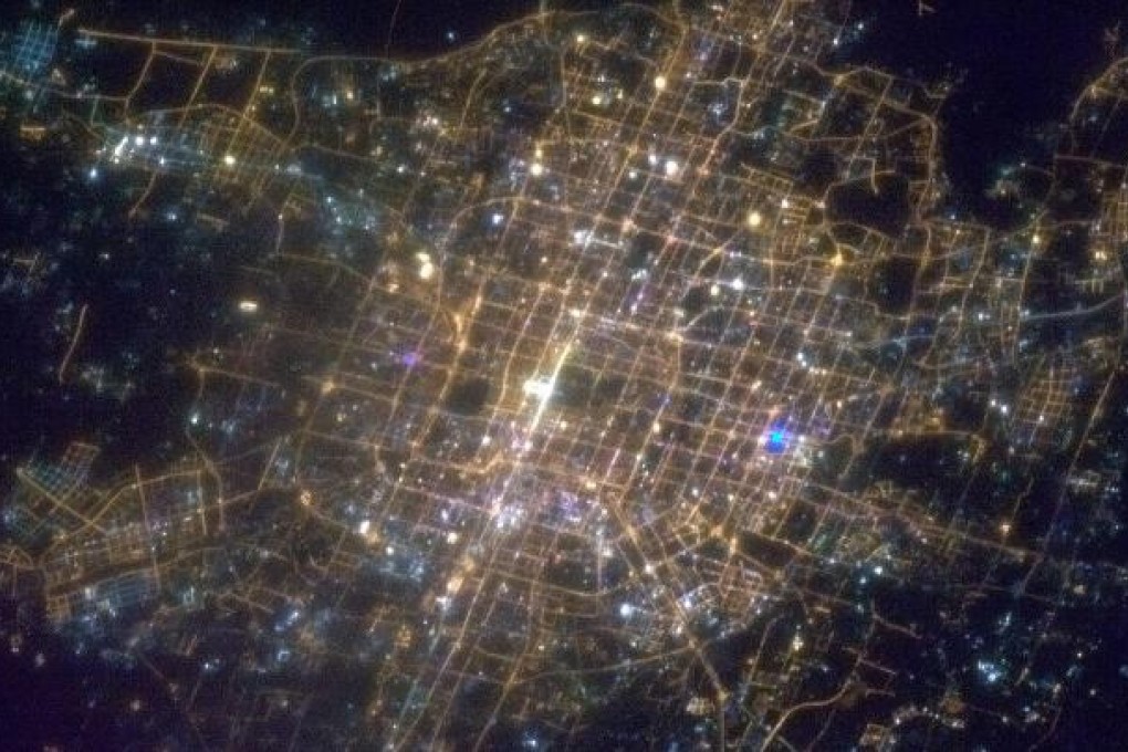 Beijing's Tiananmen Square (above) still bright with echoes of the Lunar New Year celebrations. Photo: AFP/Chris Hadfield/NASA