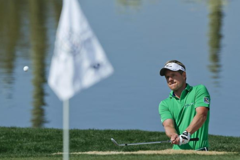 Luke Donald hits out of a bunker against Scott Piercy at the Match Play Championship tournament in Marana, Arizona. Photo: AP