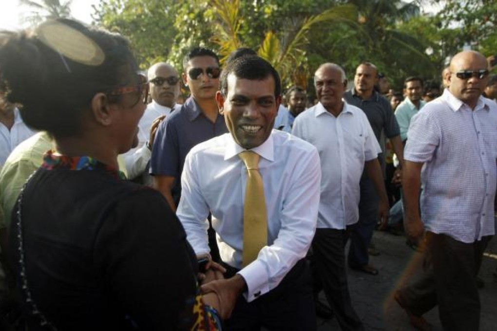Mohamed Nasheed shakes hands with a supporter in Male. Photo: AP