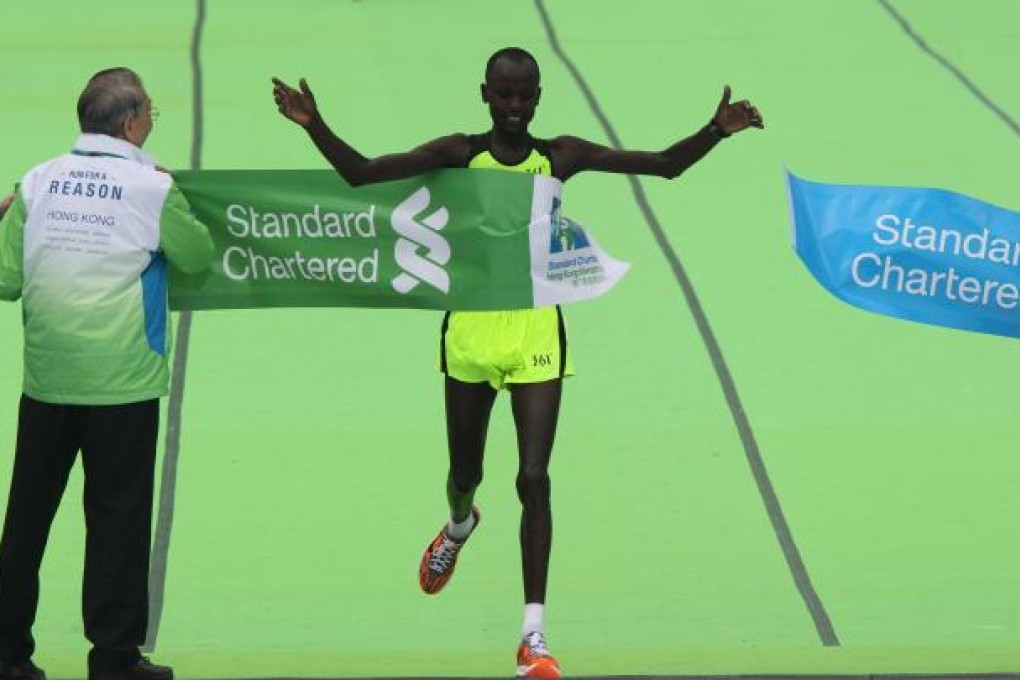 Julius Maisei of Kenya celebrates after crossing the finish line to win the Hong Kong Marathon on Sunday. Photo: K.Y. Cheng