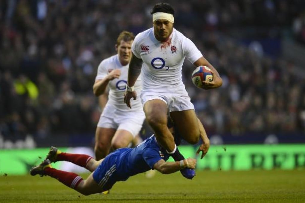 England's centre Manu Tuilagi breaks through the French defence. Photo: AFP