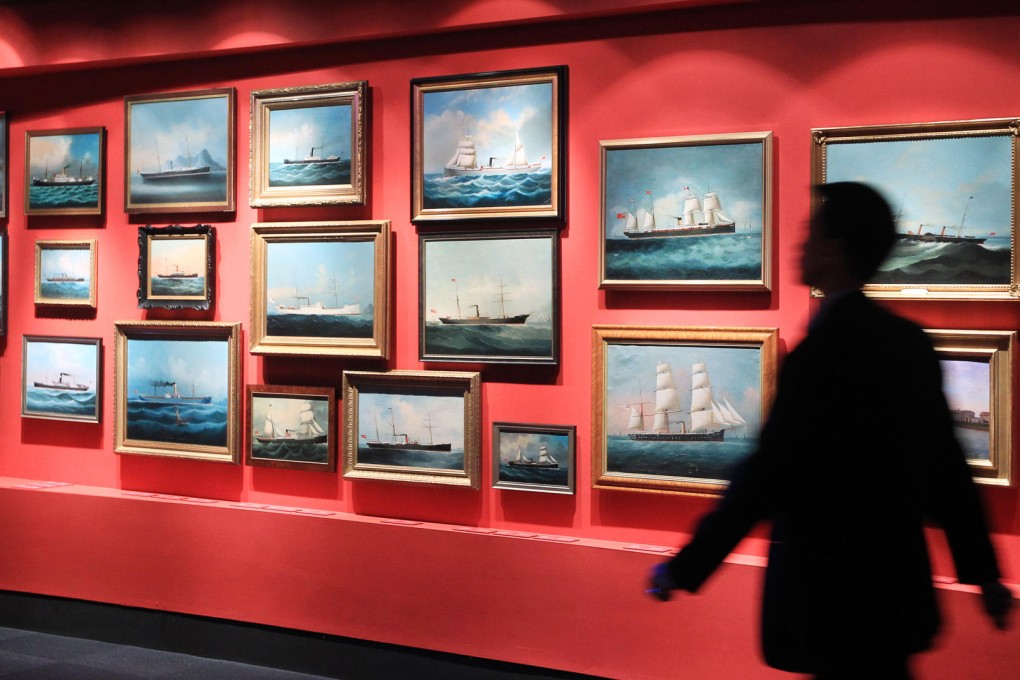 Paintings of ships on display.