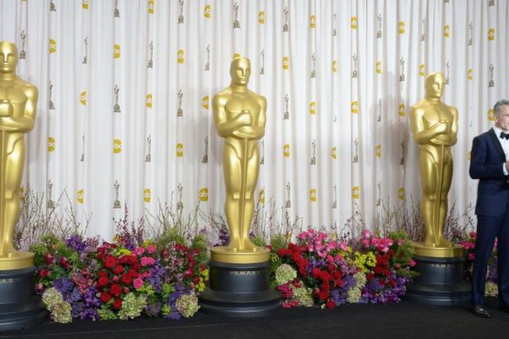 Daniel Day-Lewis holds his Oscar, presented for his portrayal of US civil war president Abraham Lincoln during the 85th Academy Awards ceremony in Hollywood.Photo: AFP
