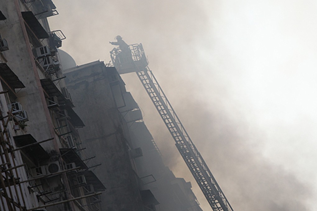 Firemen use a ladder to fight the deadly November 2011 fire at Fa Yuen Street in Mong Kok. Photo: David Wong