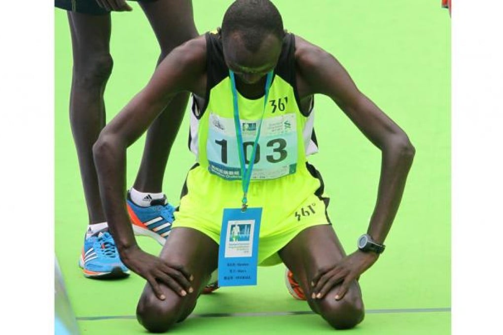 Julius Maisei composes himself after making it third time lucky in yesterday's Standard Chartered Hong Kong Marathon, having finished fourth last year and runner-up in 2011. Photo: K.Y. Cheng