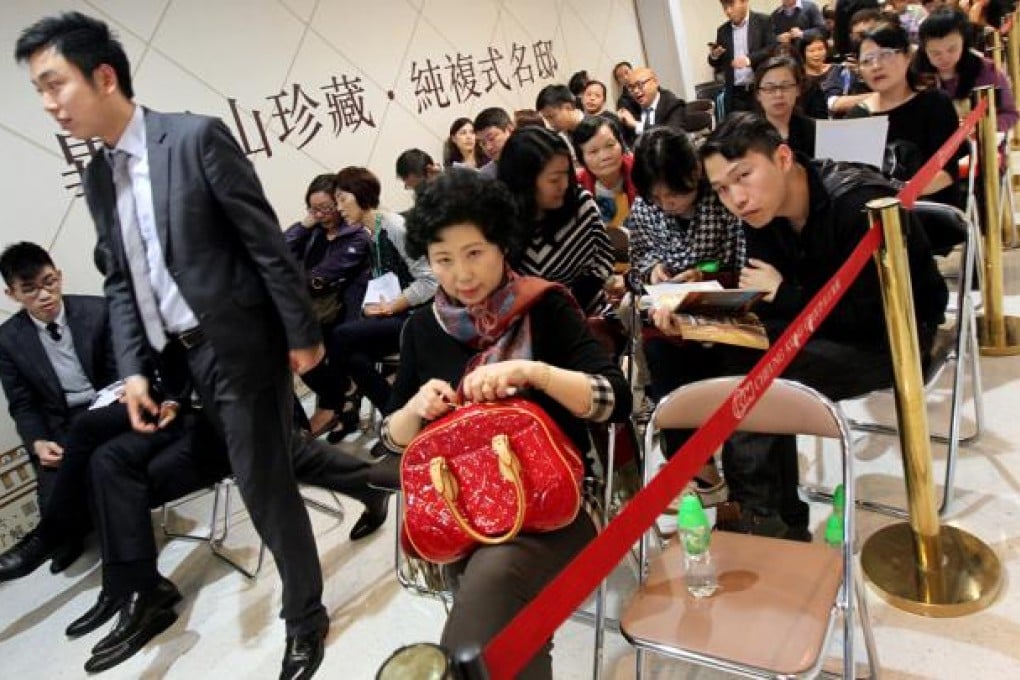 Property agents and buyers gather at the sales office of Apex Horizon hotel in Hung Hom as Cheung Kong Holdings sells more unit of the hotel. Photo: David Wong