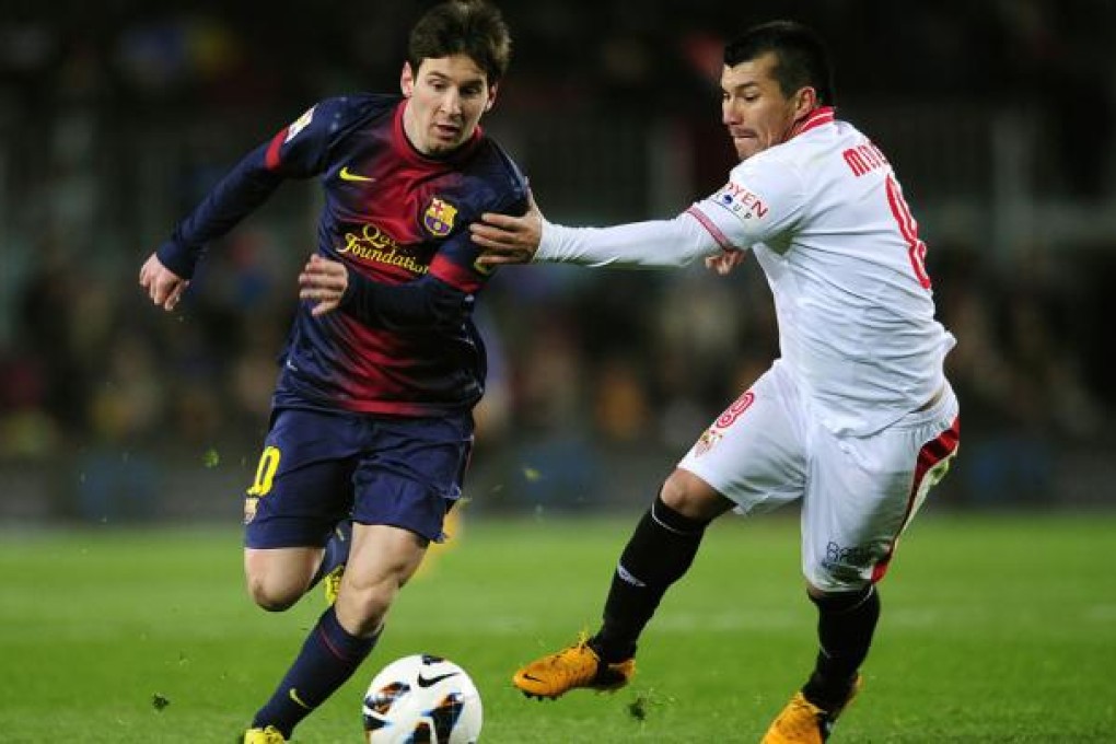 Lionel Messi scored in the 2-1 win over a stuffy Sevilla. Photo: AP