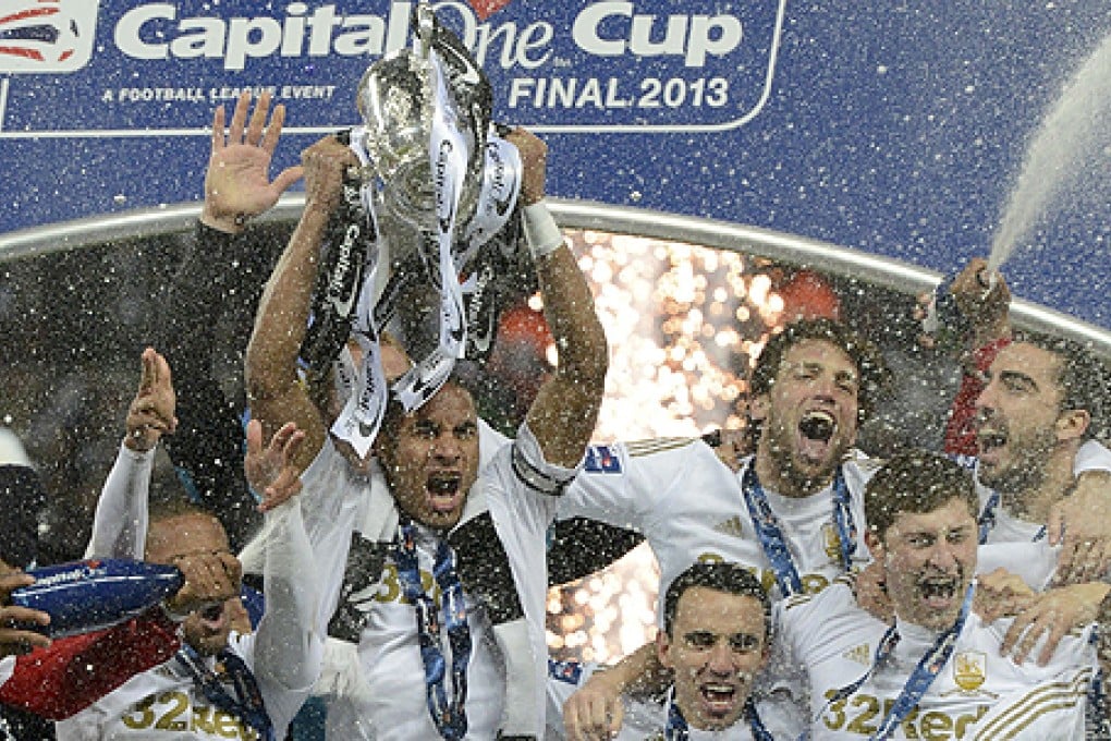 Swansea City's captain Ashley Williams celebrates with the rest of the team after winning the English League Cup final at Wembley Stadium in London on Sunday. Photo: Reuters