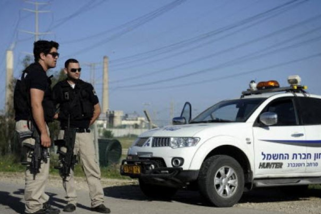 Israeli security forces in the southern city of Ashkelon on Tuesday after a rocket fired from the Gaza Strip landed near the city. Photo: AP