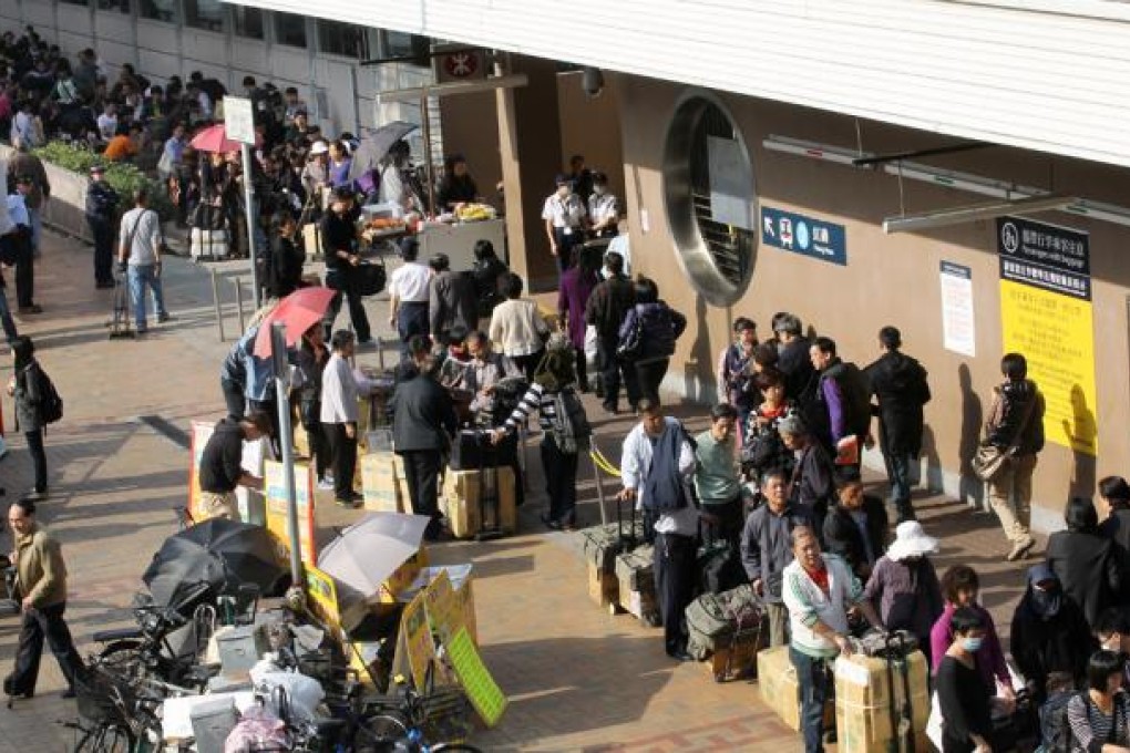 Parallel traders carry their goods at Sheung Shui train station. Photo: Edward Wong