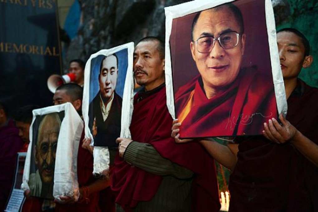 Exile Tibetans carry portraits of the Dalai Lama (right), the late Panchen Lama (centre), and Mahatma Gandhi at a candlelight vigil to mourn the deaths of self-immolators in Dharamshala. Photo: AFP