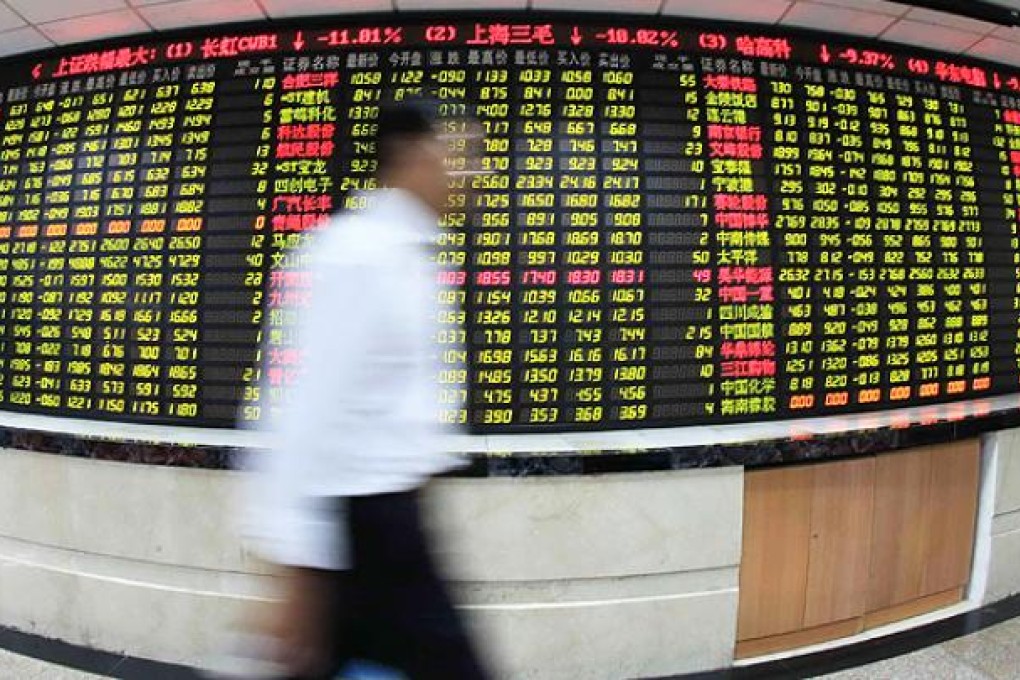 A board displays stock prices at a brokerage in Shanghai. Photo: Xinhua