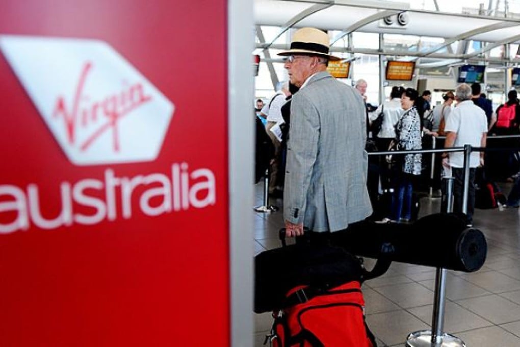 Virgin Australia's net income slumped 56pc in the six months to December. Photo: EPA