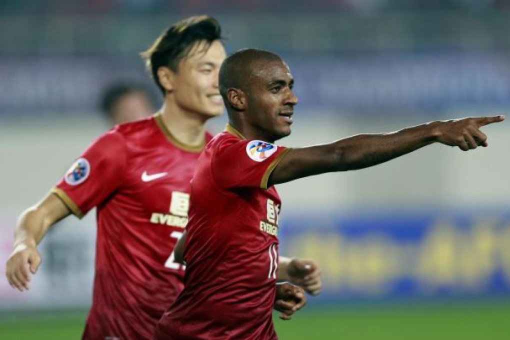 Guangzhou Evergrande's Muriqui (right) celebrates with teammate Gao Lin after scoring the second goal against Urawa Red Diamonds in Guangzhou's Tianhe stadium. Photo: AFP
