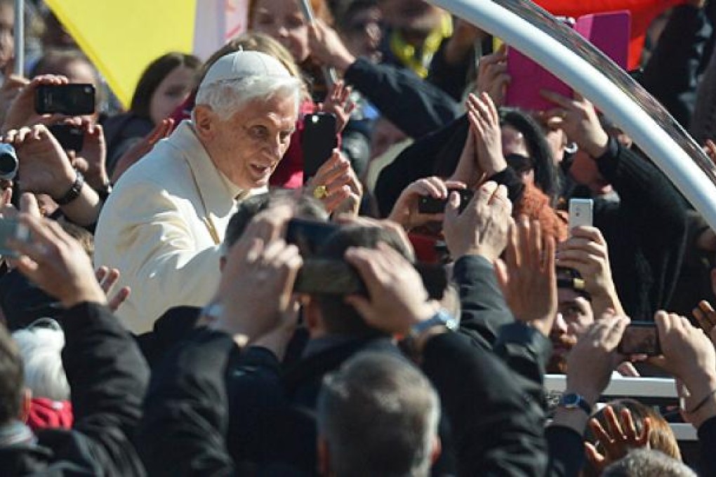 Pope Benedict XVI waves as he arrives in St Peter's Square for his last weekly audience on Wednesday. Photo: AFP