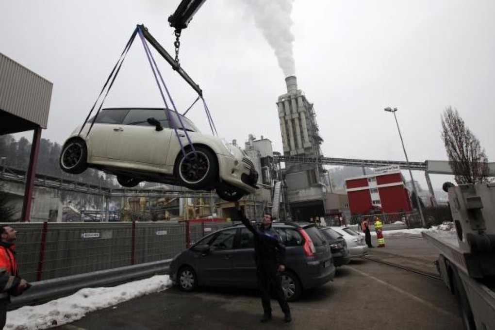 Police remove a car from the area of crime. Photo: Reuters