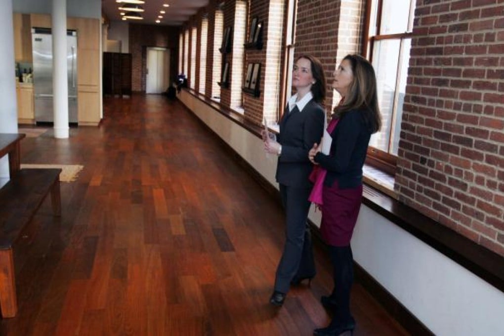 "How do you say, 'You've been gazumped' in Putonghua, again?" Estate agents give a loft apartment in Manhattan the once over. Photo: Bloomberg News