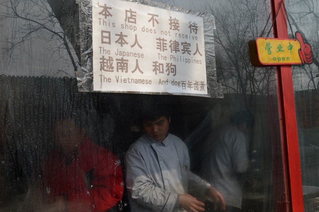 The sign in this Beijing restaurant caused an international backlash. Photo: AFP