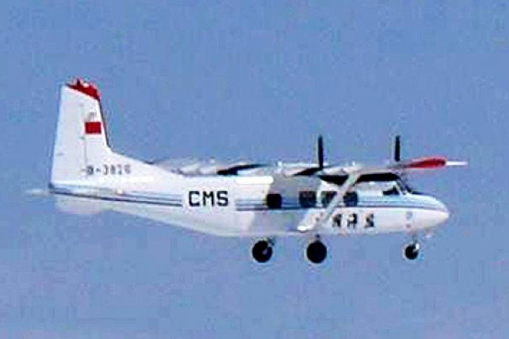 A Chinese government plane flies near the disputed Diaoyu/Senkaku islands in the East China Sea on Thursday. Photo: AFP