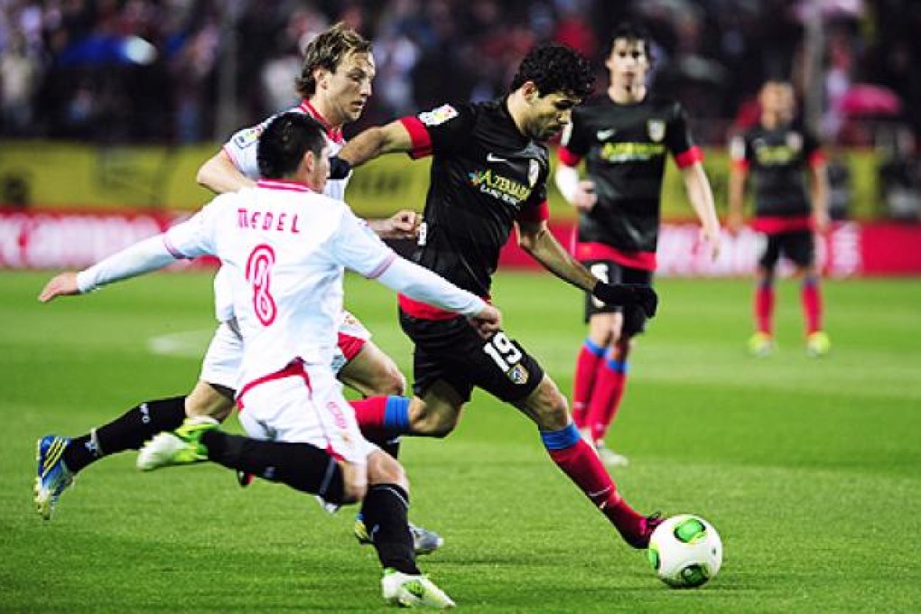 Sevilla's Gary Medel (left) chases Atletico Madrid's Diego da Silva Costa on Wednesday. Photo: AFP