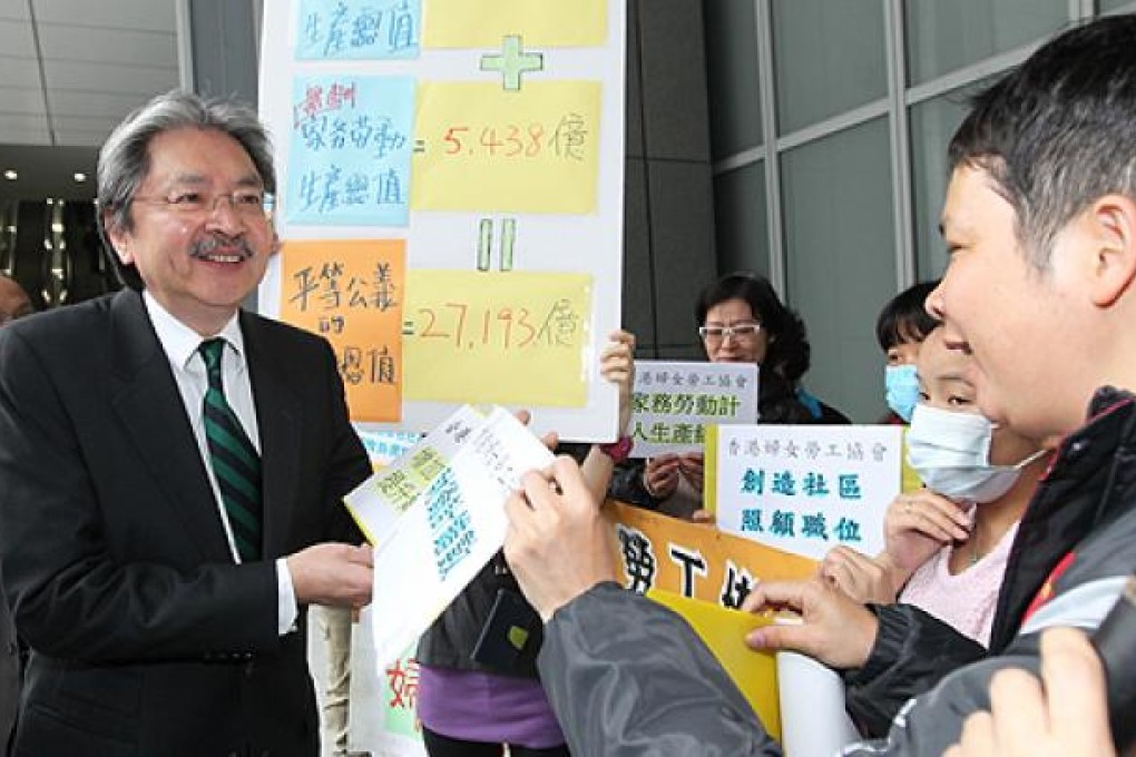 Financial Secretary John Tsang Chun-wah is stopped by protesters outside government offices in Admiralty on Thursday. Photo: May Tse