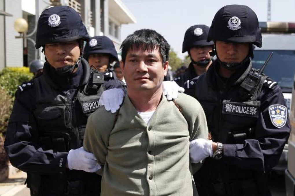 Drug lord Naw Kham is marched to his execution by police yesterday - he and three accomplices were killed by lethal injection. Photo: AP
