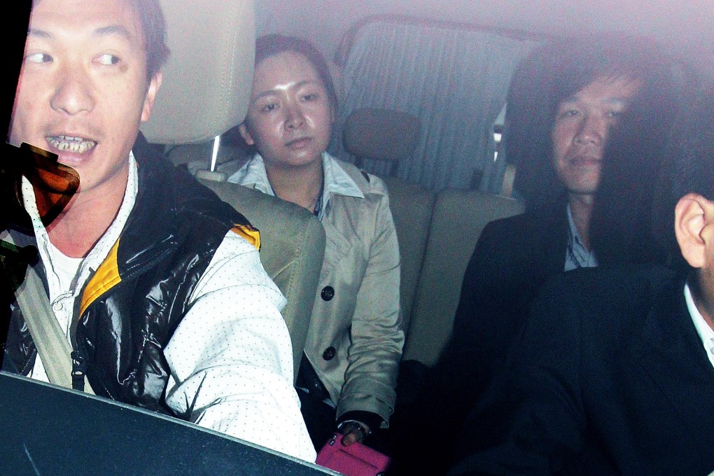 One of the girls who returned to Hong Kong is seen being taken to the New Territories North regional headquarters under police escort yesterday. Photo: David Wong