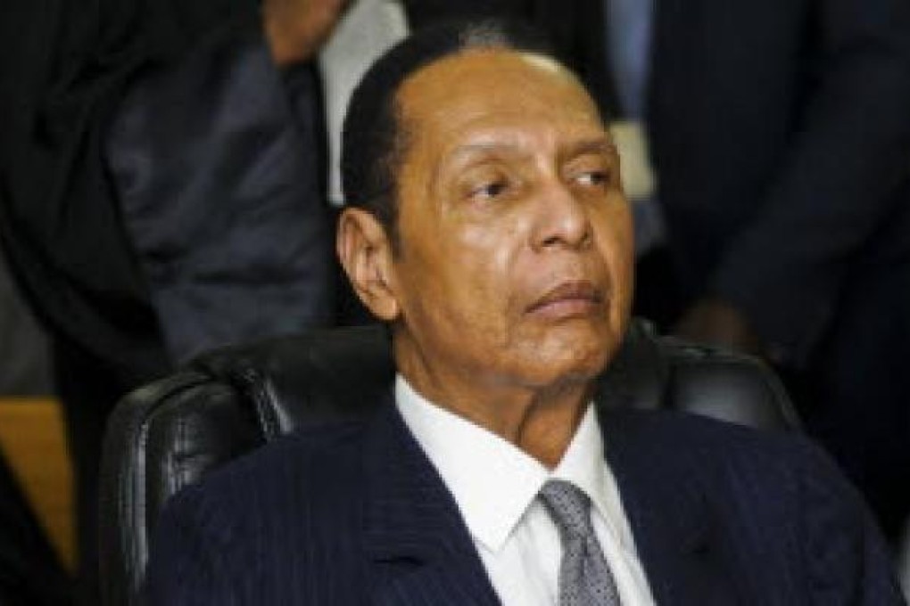 Former Haitian Dictator Duvalier listens as his defense council testifies during an appeals court hearing in Port-au-Prince. Photo: Reuters