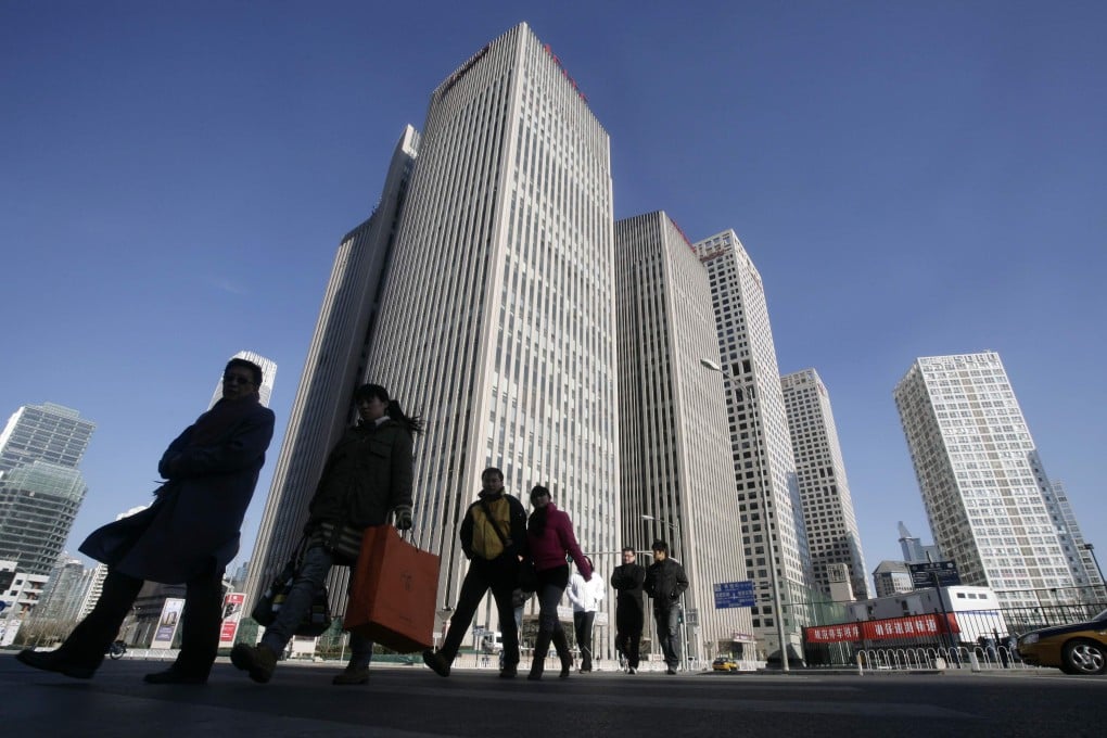 People walk near office buildings in Beijing's central business district. Photo: Reuters