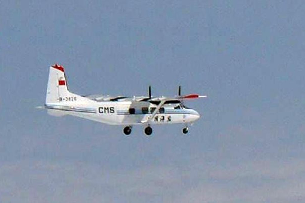 A Chinese government plane flies near the disputed Diaoyu/Senkaku islands in the East China Sea on Thursday. Photo: AFP