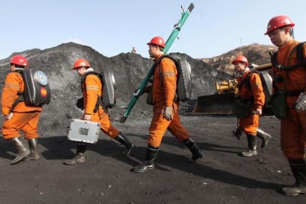 Rescuers prepare to help trapped coal miners In the southern Guangxi region in 2011. On Friday, a fire at a coal mine in northern China has killed 11. Two others are missing.