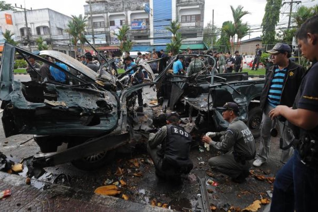 Officials inspect the site of the second explosion. Photo: AFP
