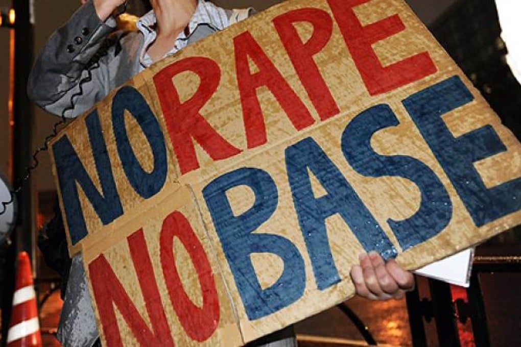Civic group members hold placards to protest over the alleged rape of a local woman by two US servicemen in Okinawa, in front of the prime minister's official residence in Tokyo in October. Photo: AFP