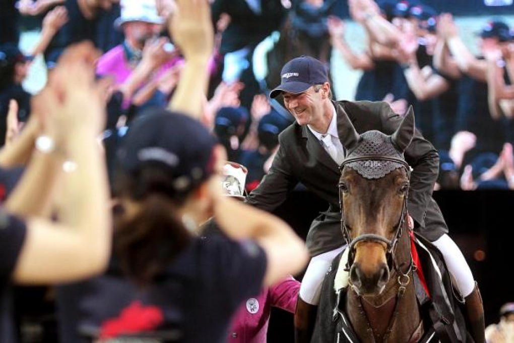 Frenchman Patrice Delaveau is greeted by an enthusiastic crowd after he captures his third win in three nights at the AsiaWorld-Expo. Photo: K. Y. Cheng